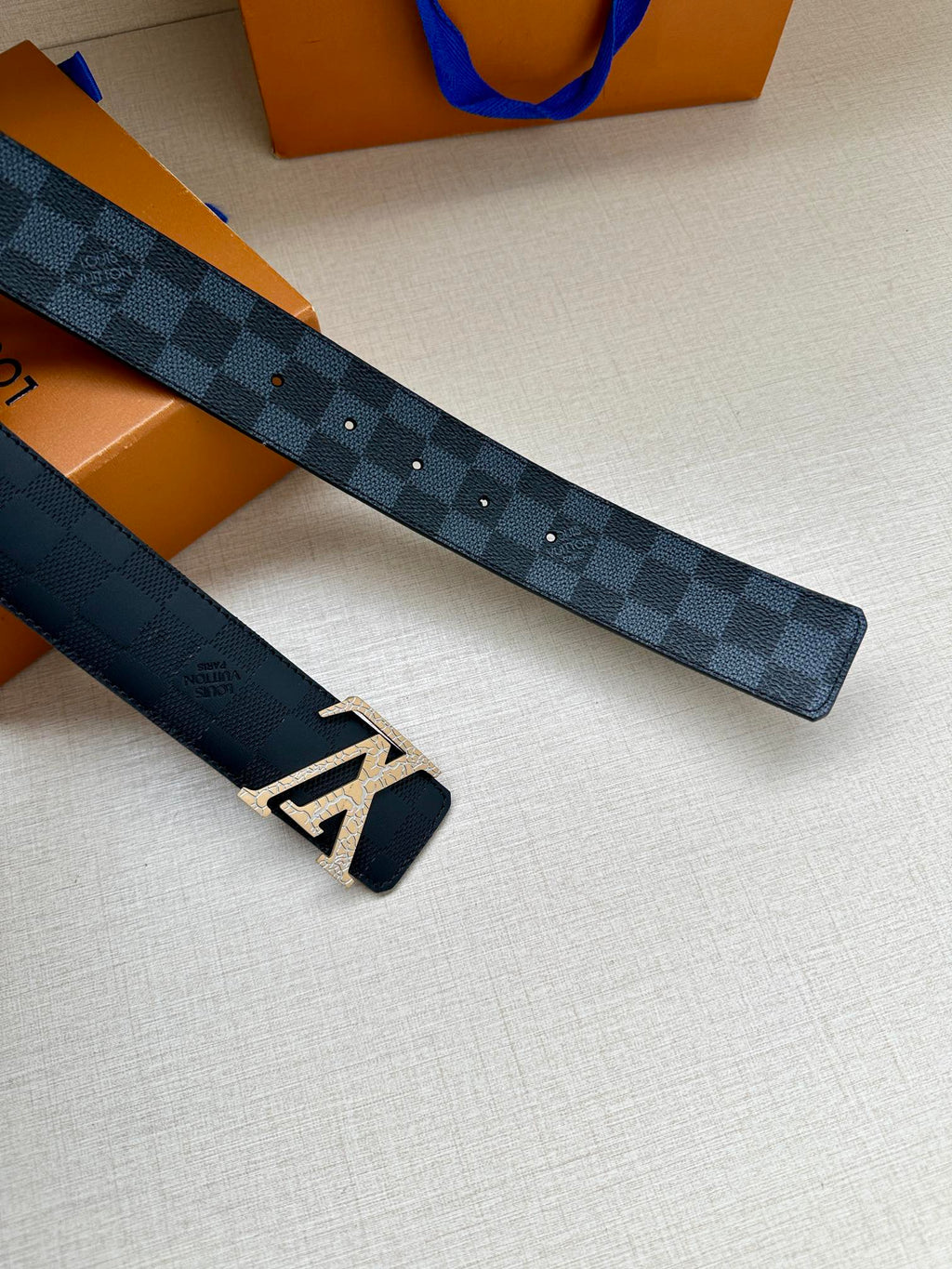 Louis Vuitton belt strap with dark blue checkered pattern and silver-tone LV buckle ends
