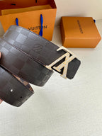 Louis Vuitton belt with dark checker strap and metallic LV buckle on end tab