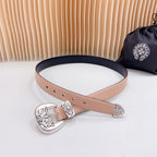 Tan leather belt with ornate silver-tone buckle and navy trim, adjustable eyelets