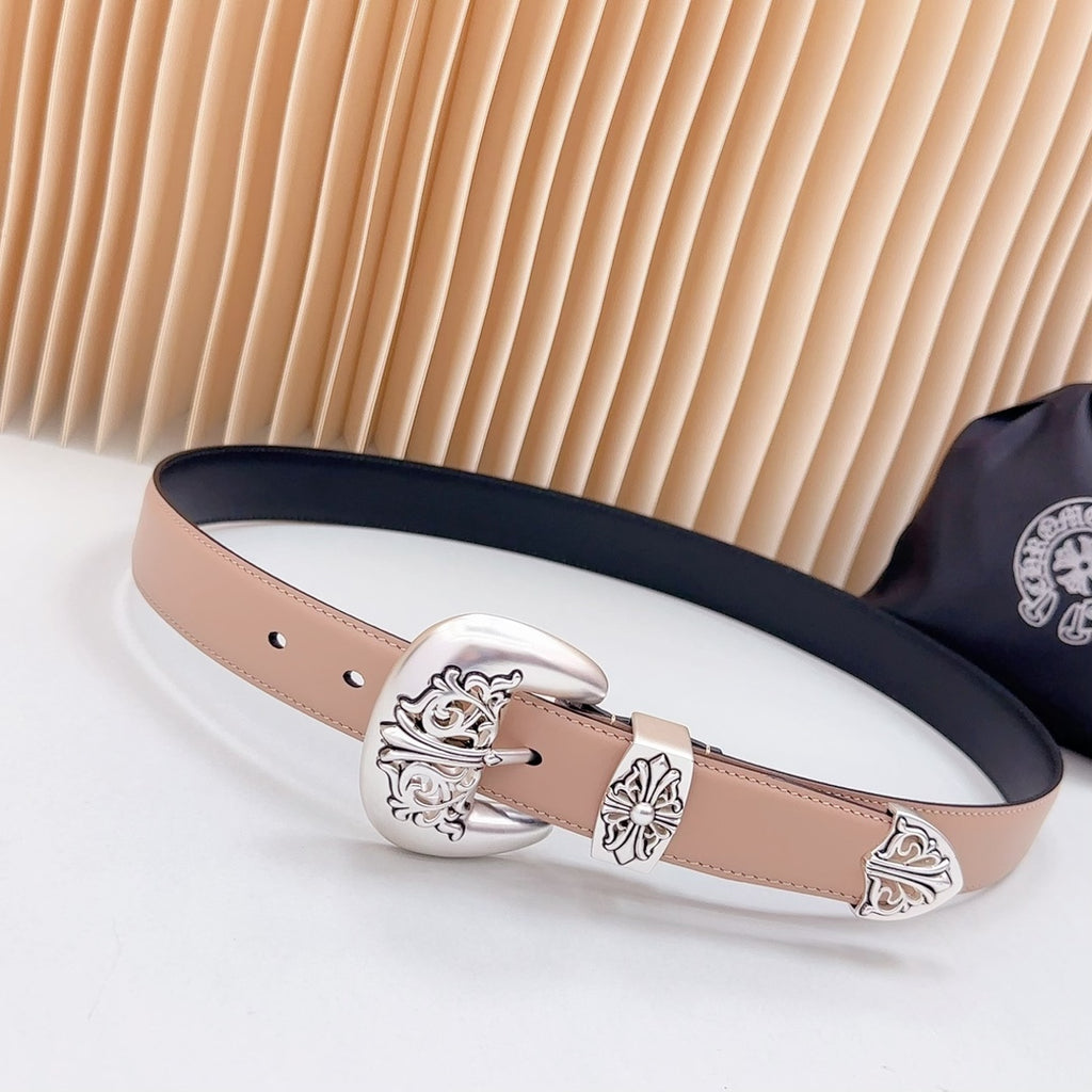 Leather belt with navy edge and ornate silver-tone buckle, tan strap with eyelets