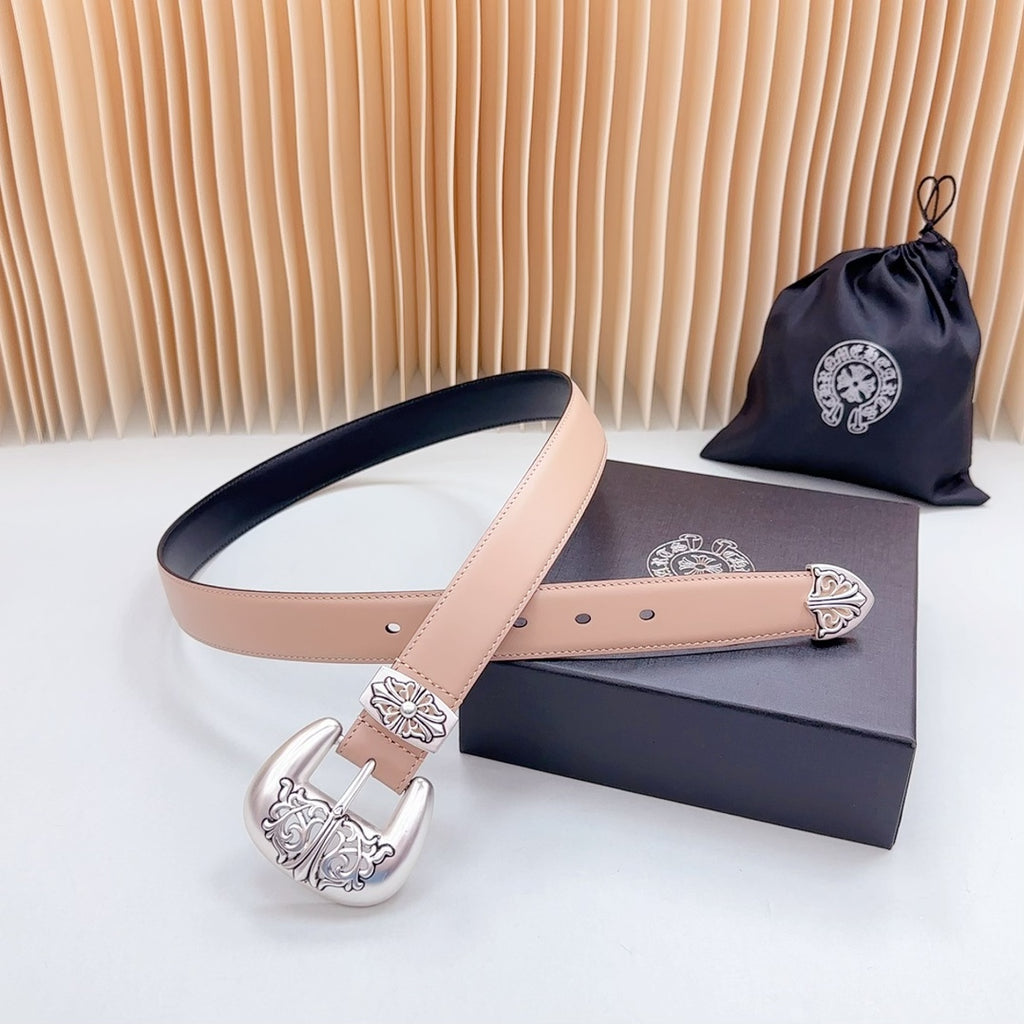 Tan leather belt with ornate silver-tone buckle and navy edge, visible strap and buckle
