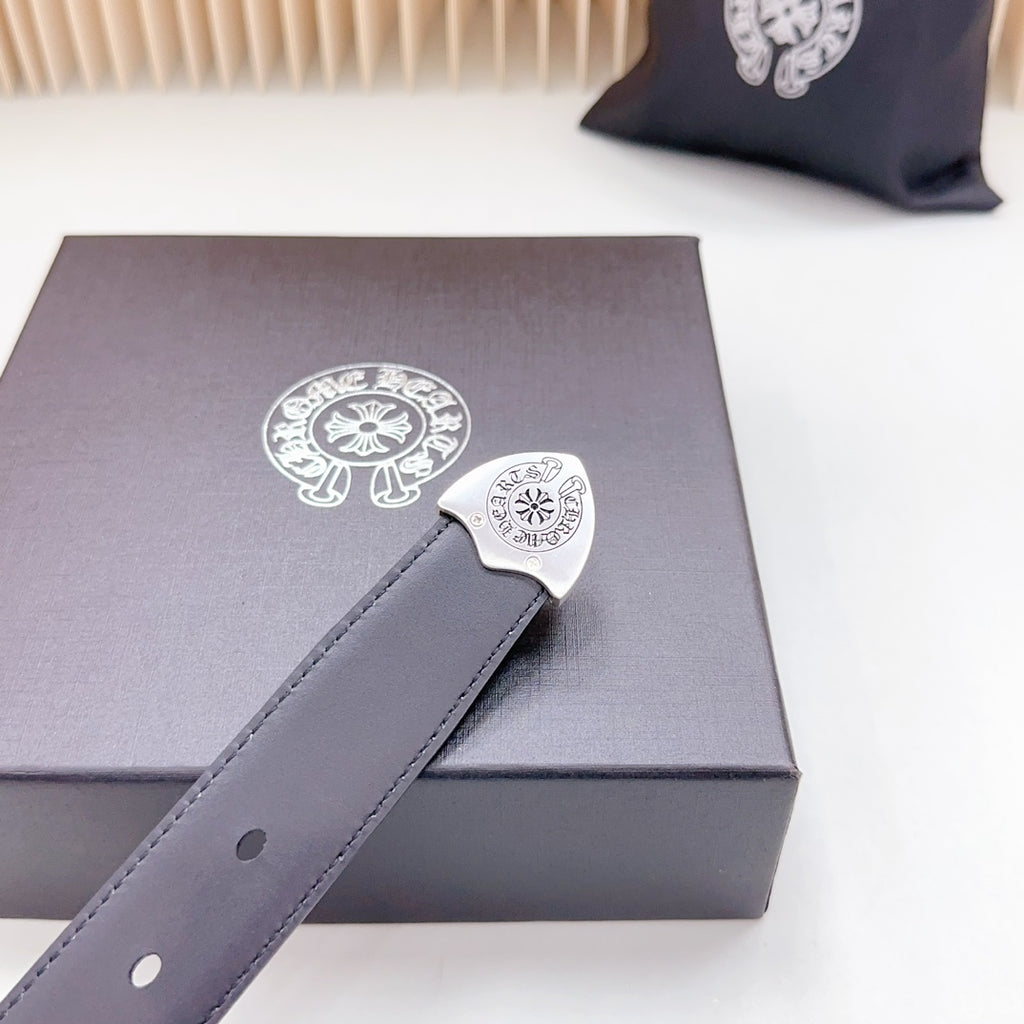 Dark leather belt close-up with ornate silver-tone buckle and single adjustment hole