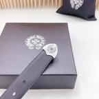 Dark leather belt close-up with ornate silver-tone buckle and single adjustment hole