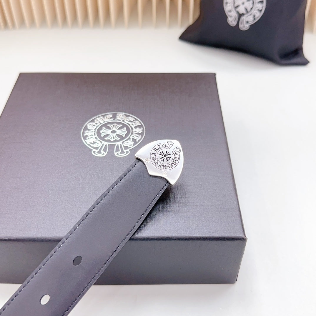 Dark leather belt close-up with ornate silver-tone buckle and single adjustment hole