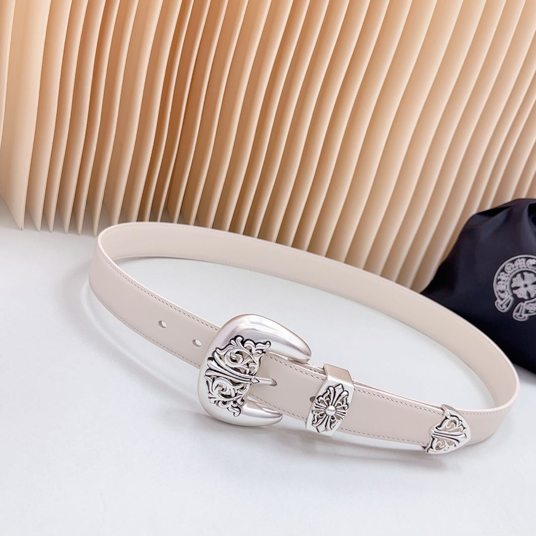 Light beige leather belt with ornate chrome buckle and carved floral detailing