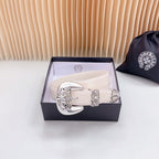 Beige leather belt with ornate chrome buckle and decorative engraved trim on strap