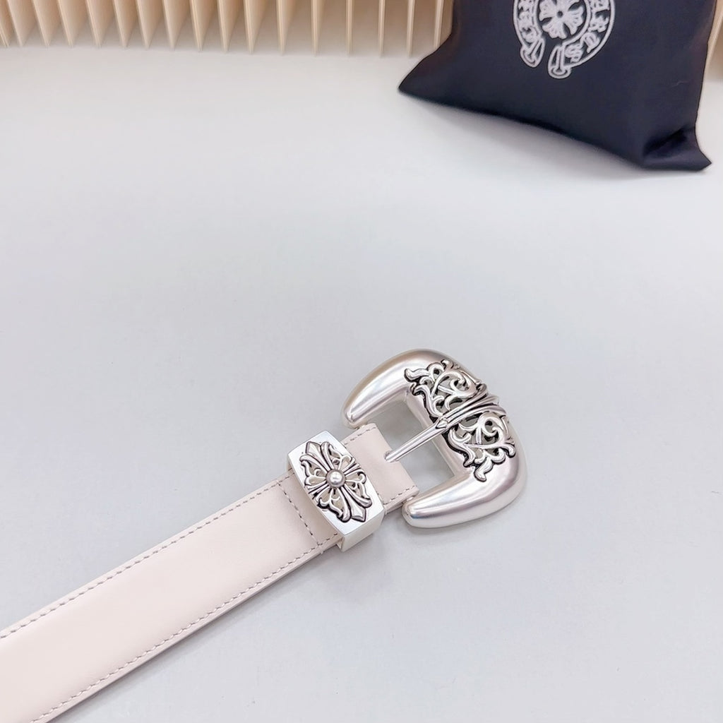 Beige leather belt end with chrome buckle and engraved floral corner details