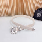 Beige leather belt with decorative chrome buckle and matching floral engraved accents