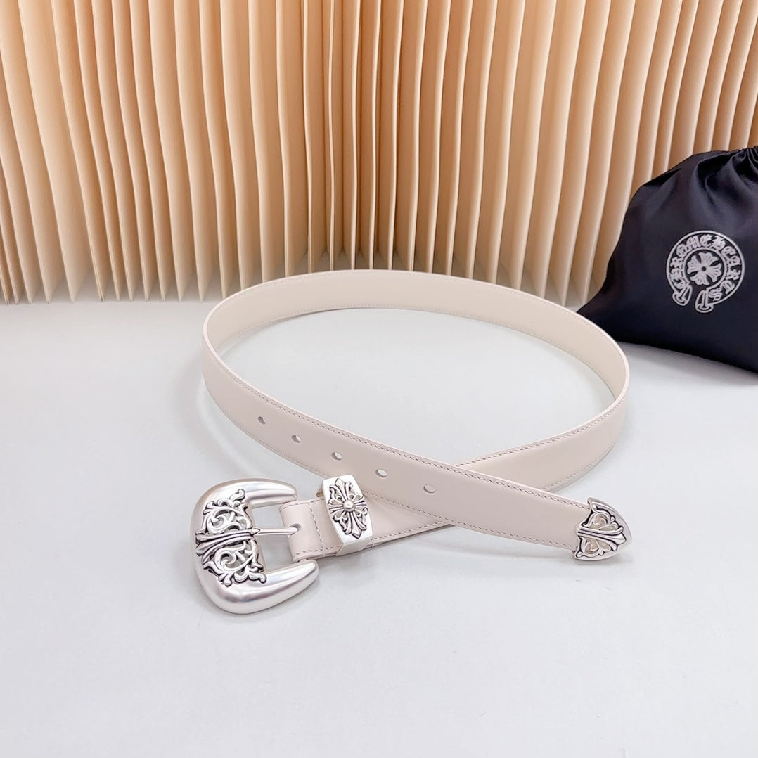Beige leather belt with decorative chrome buckle and matching floral engraved accents