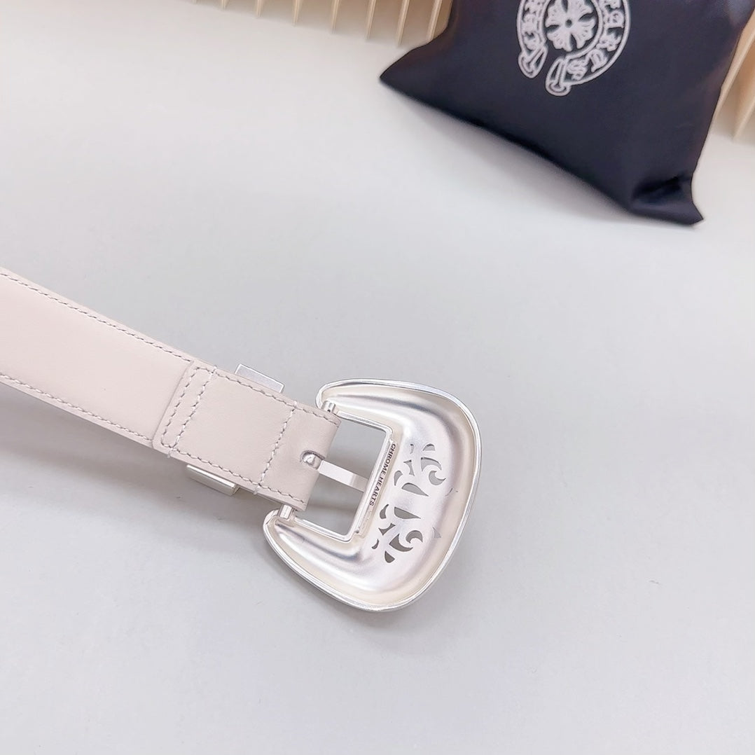 Beige leather belt with adjustable holes and silver-tone buckle with ornate engraving