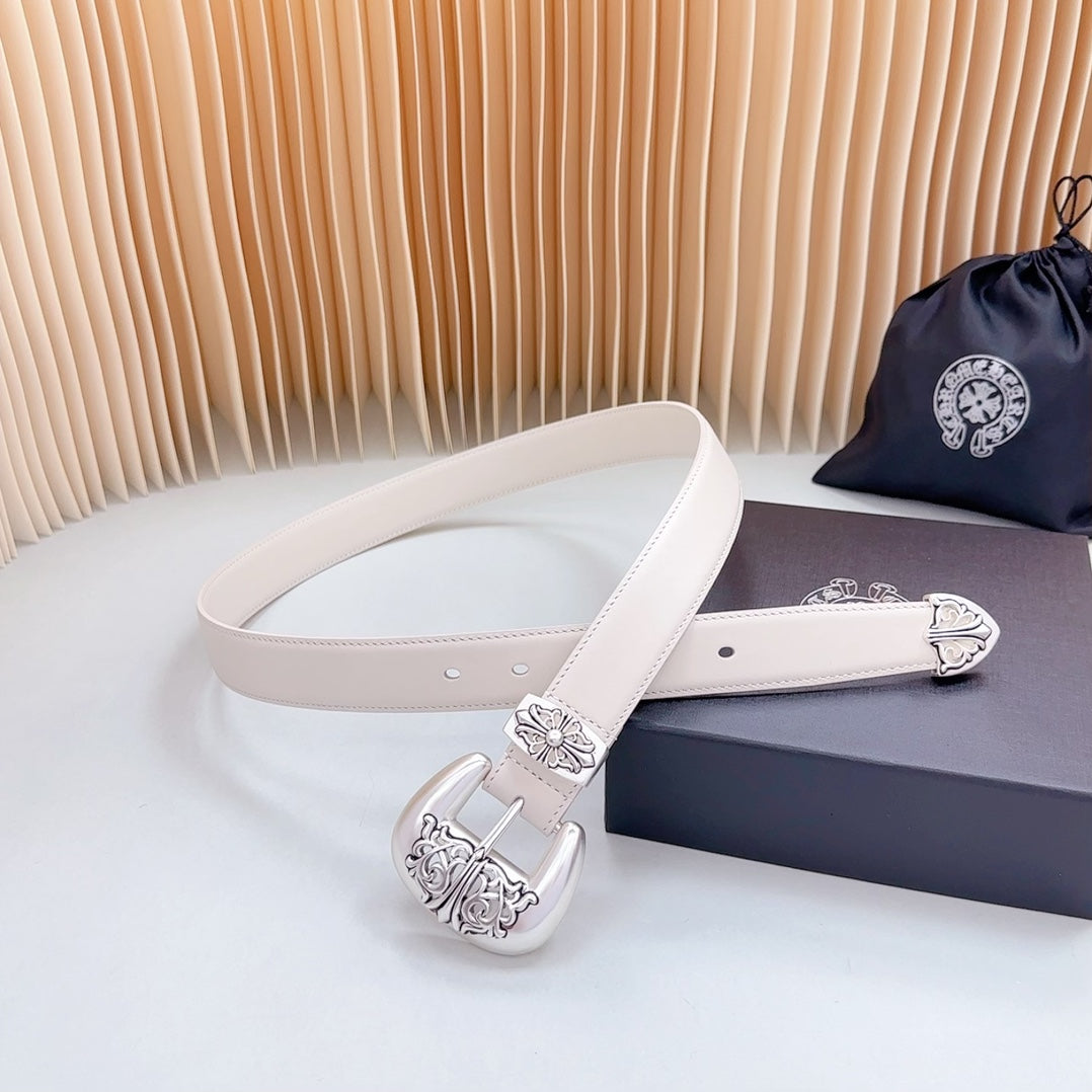 Beige leather belt with chrome buckle featuring carved floral and scrollwork