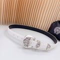 White leather belt with silver ornate buckle and keeper detail