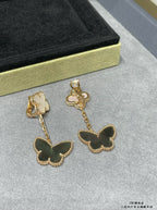 Butterfly dangle earrings with white clover tops and dark green butterfly charms