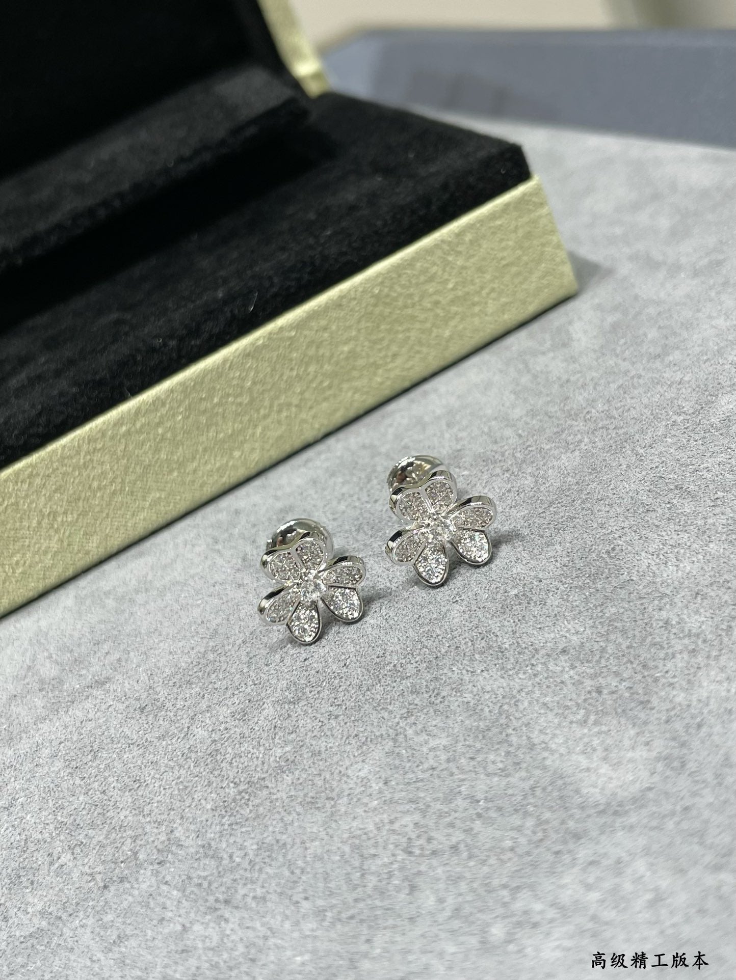 Small four-leaf clover stud earrings in silver-tone with clear stones