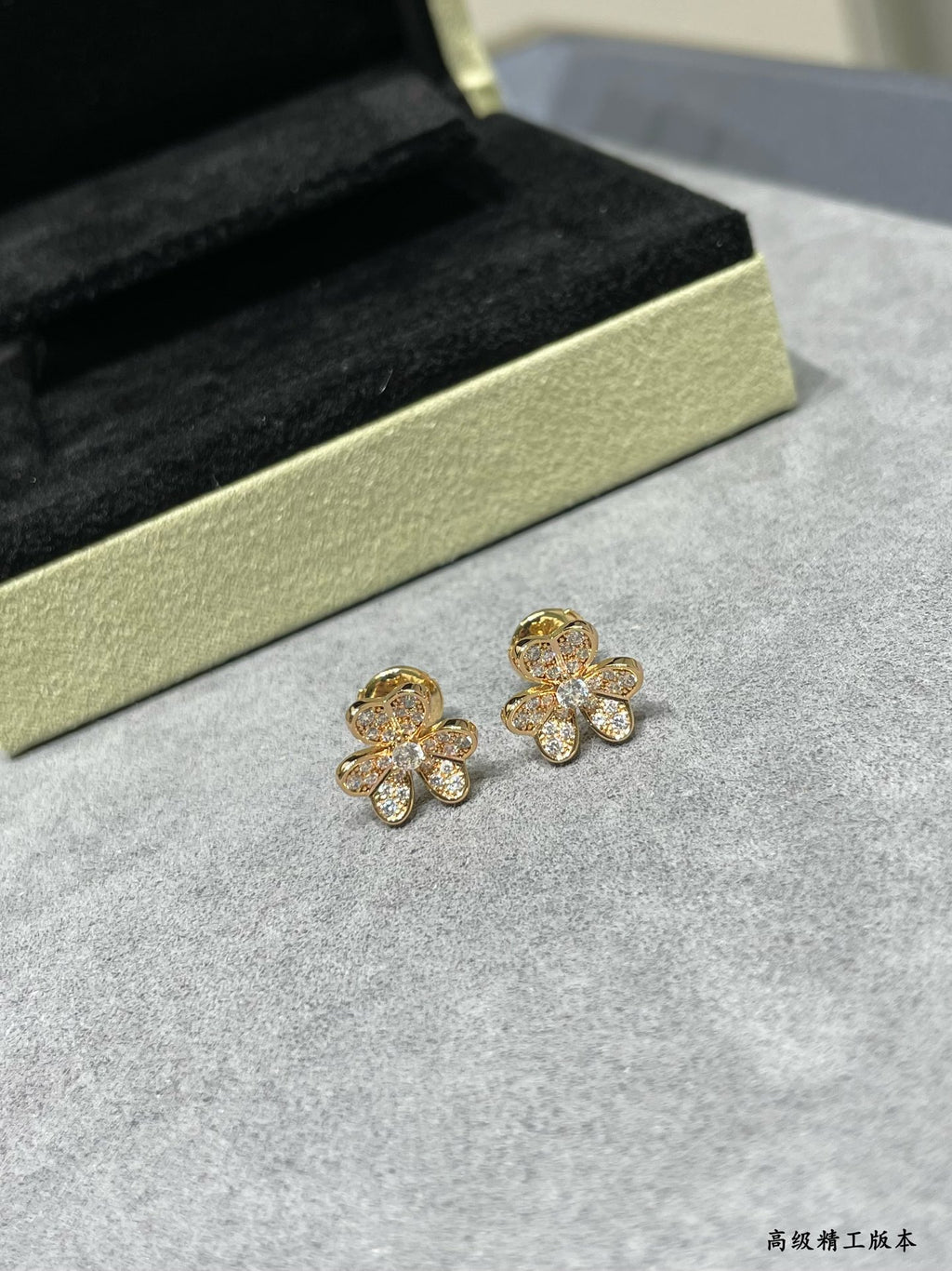 Four-leaf clover stud earrings in gold-tone with sparkling clear stones