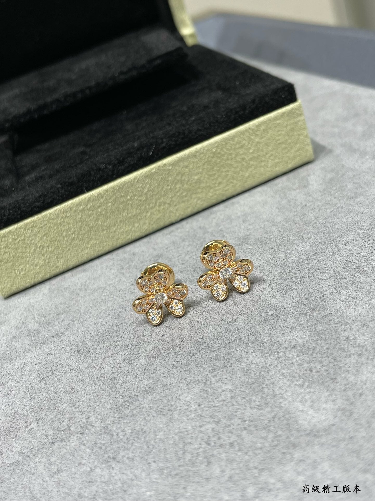 Four-leaf clover stud earrings in gold-tone with sparkling clear stones