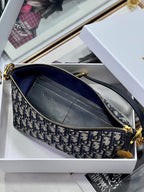 Dior crossbody bag with blue Dior logo pattern, zip top, and interior pocket detail