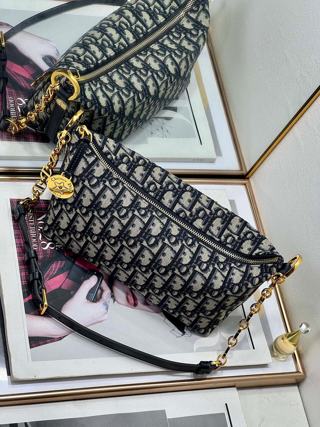 Dior patterned shoulder bag with zip top, gold-tone hardware, and chain crossbody strap
