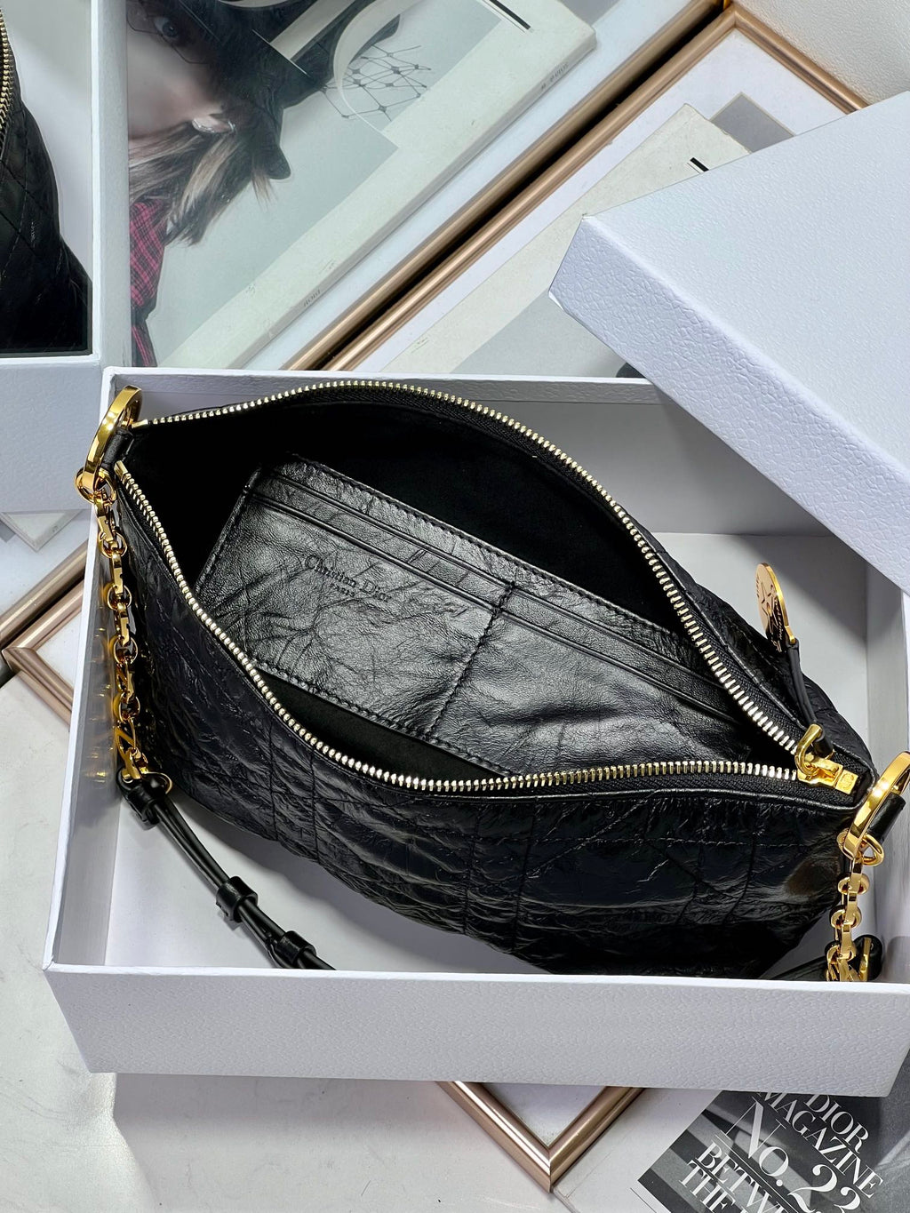 Dior black hobo bag interior with zip closure, gold chain strap, and hardware.