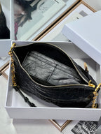 Dior black hobo bag interior with zip closure, gold chain strap, and hardware.