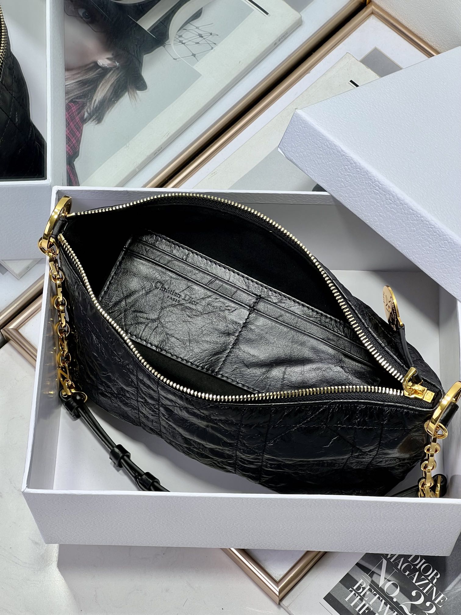 Dior black hobo bag interior with zip closure, gold chain strap, and hardware.