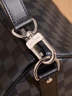 Men's Louis Vuitton key clasp on checkered bag strap, with black leather trim