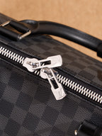 Men's Louis Vuitton checkered bag zipper pull with silver star-shaped detail