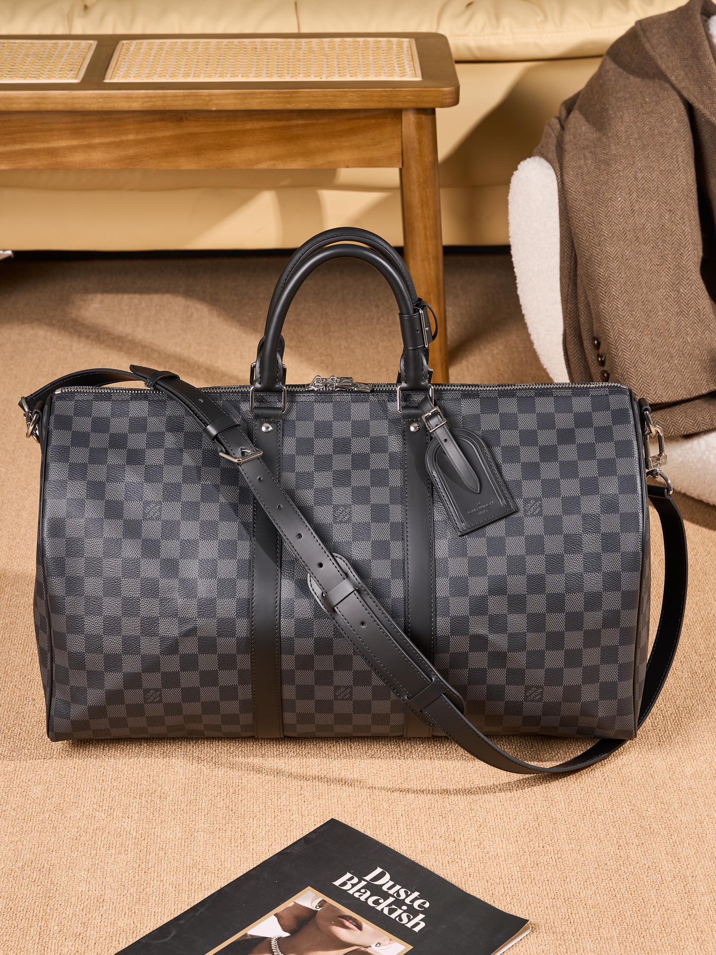 Men's Louis Vuitton checkered duffel bag with top handles and shoulder strap