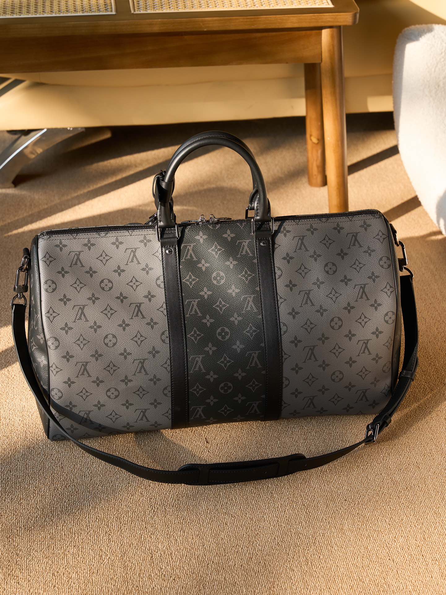 Men's Louis Vuitton duffel bag with monogram canvas and black leather center panel