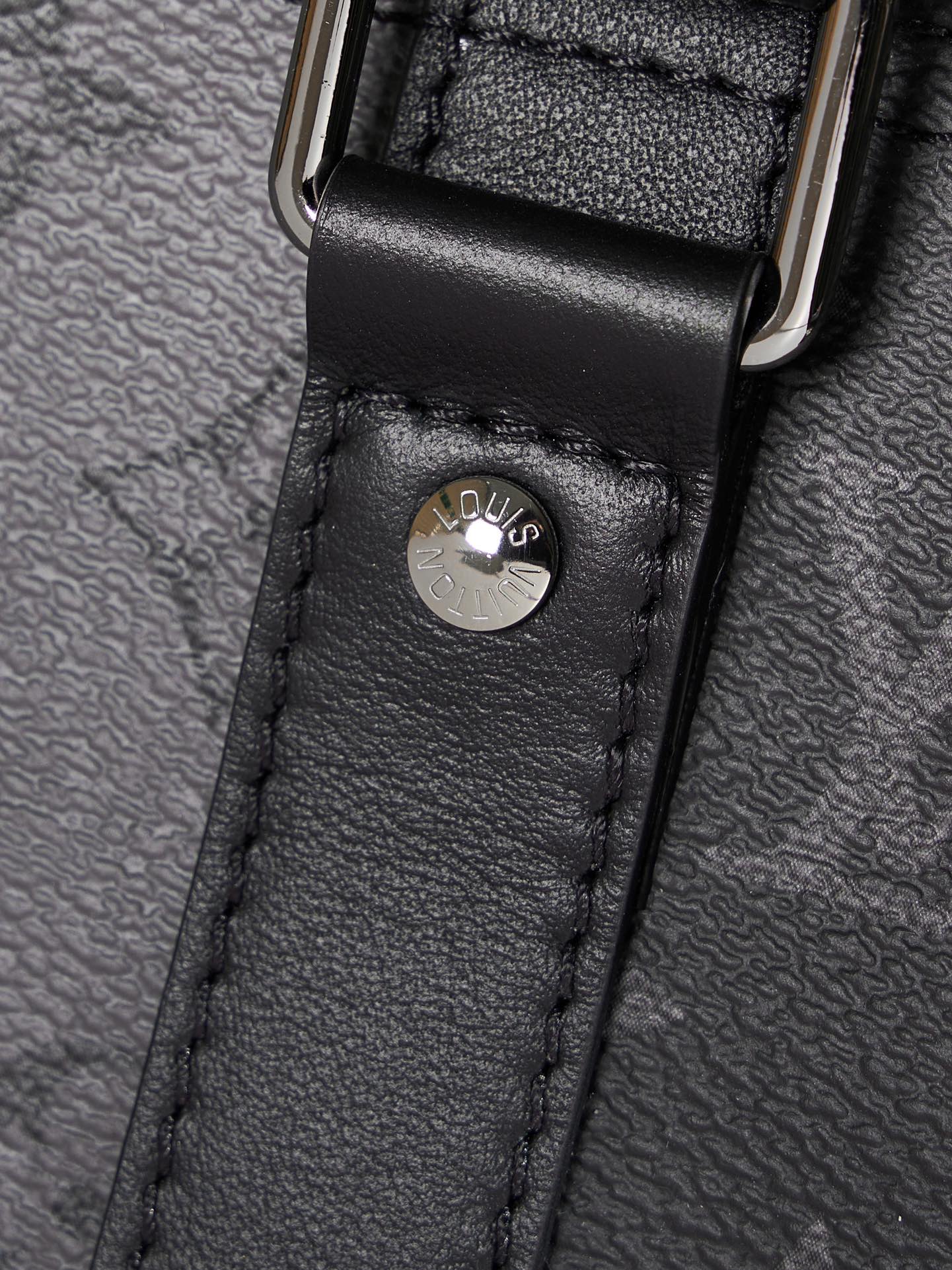 Louis Vuitton duffel bag leather loop with embossed logo on black textured leather