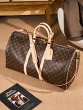 Louis Vuitton monogram duffel bag, tan leather straps, top handles