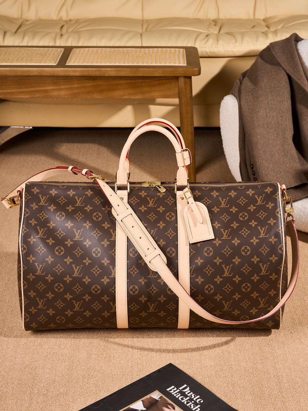 Monogram duffel bag with tan leather crossbody strap and double handles