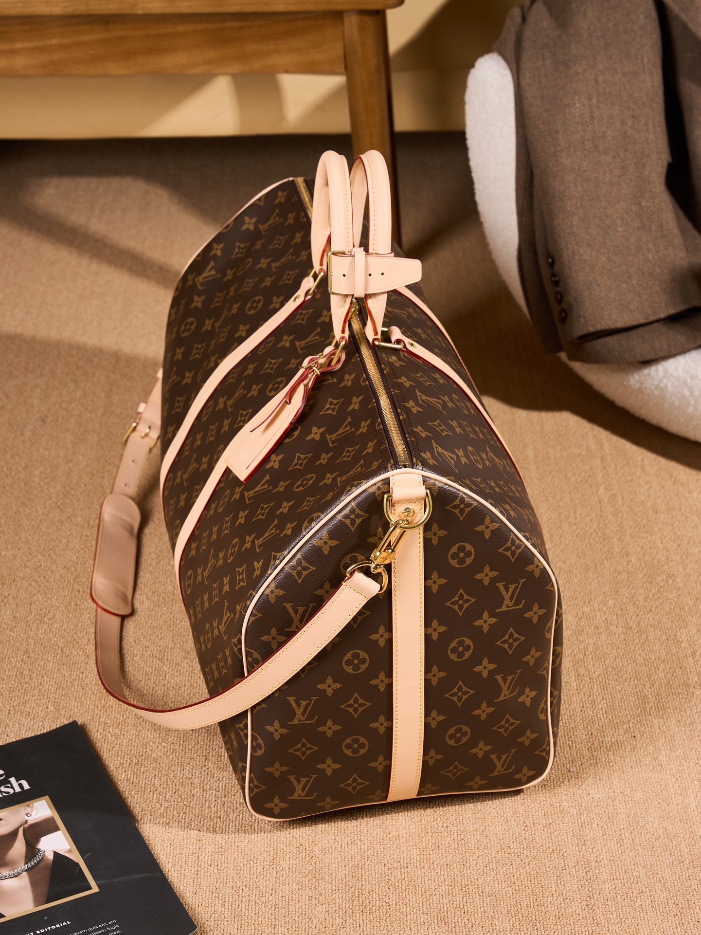 Monogram duffel bag with tan strap, front panel, and gold hardware