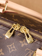 Monogram duffel bag zipper with gold hardware and leather pull tab