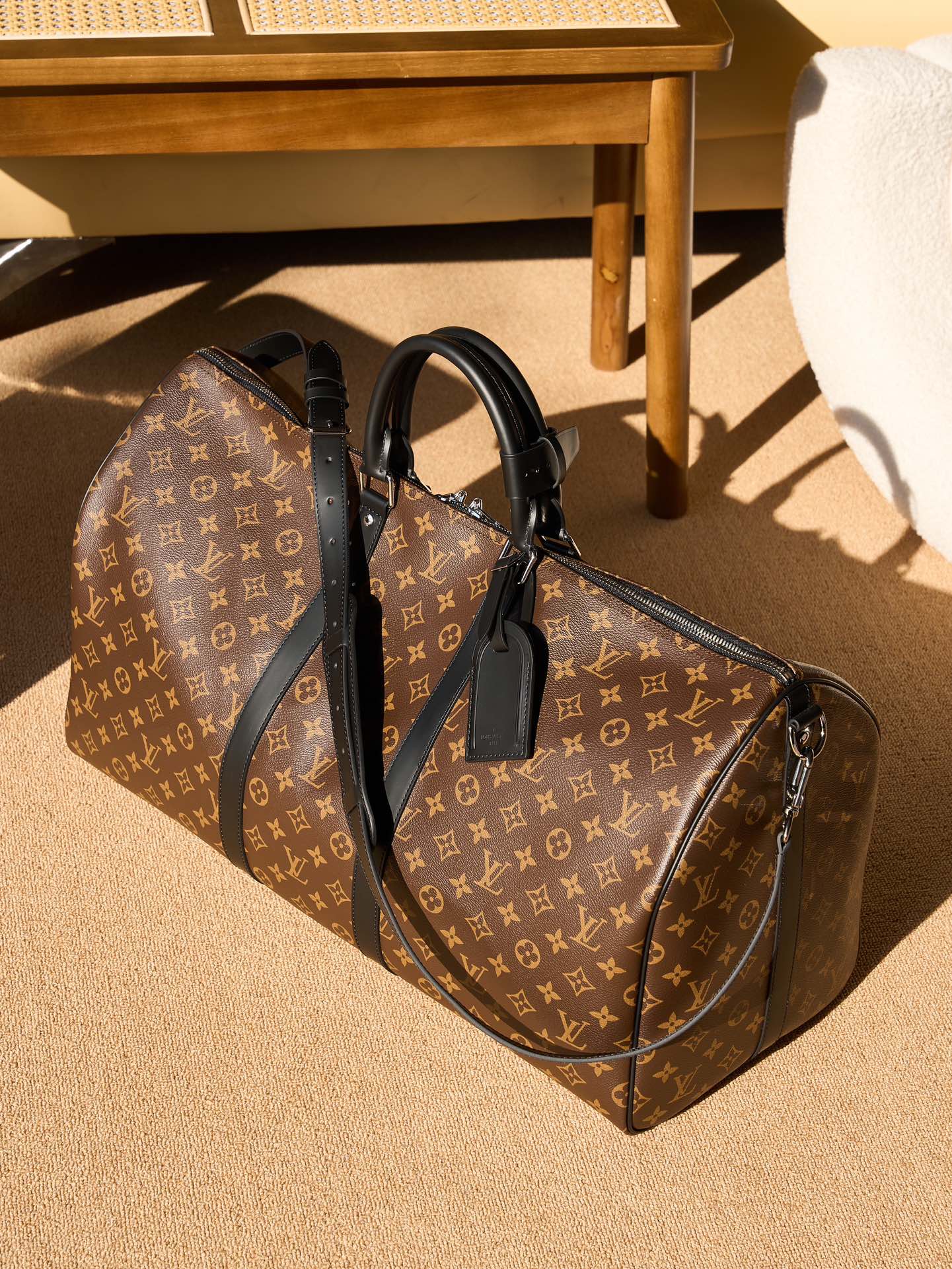 Louis Vuitton monogram duffel bag with black leather handles and shoulder strap