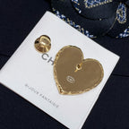 Heart-shaped gold-tone brooch with circular back piece on white Bijoux Fantaisie card