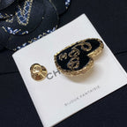 Heart-shaped gold-tone brooch with black enamel, shown with small round stud backing