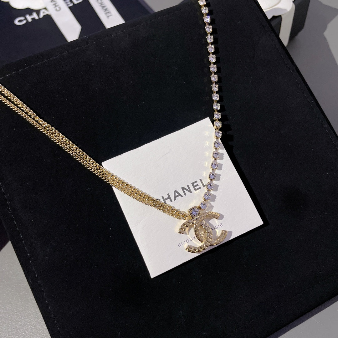 Gold-tone and crystal tennis-style pendant necklace on white tag
