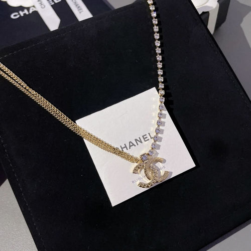 Gold-tone and crystal tennis-style pendant necklace on white tag