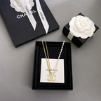 Gold-tone and crystal pendant necklace set displayed in black gift box