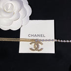 Gold chain necklace with purple crystal row and circular CC pendant charm