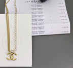 Crystal bead necklace and gold chain with clasp shown beside jewelry box label