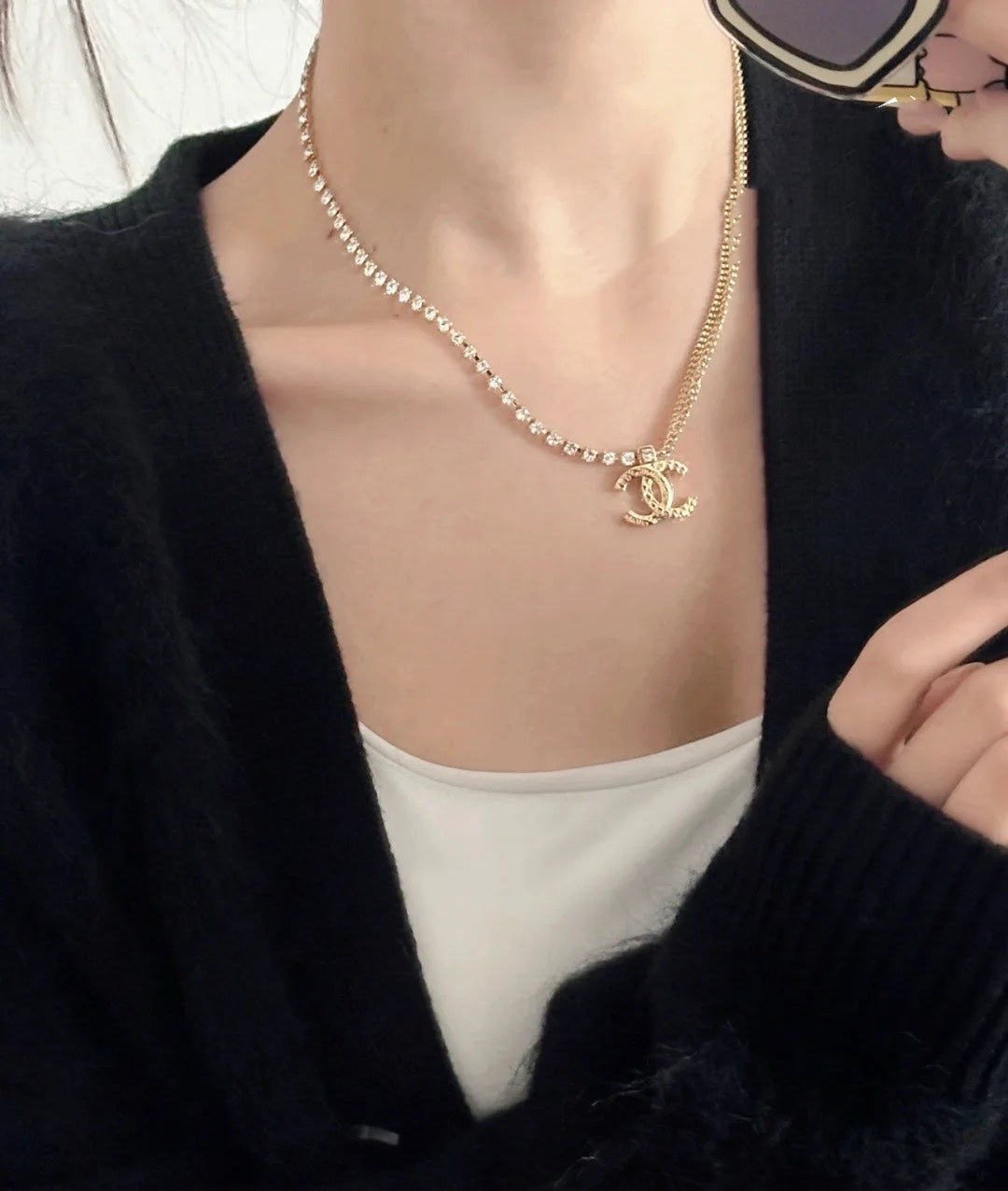 Layered pearl and gold-tone necklaces with Chanel logo pendant