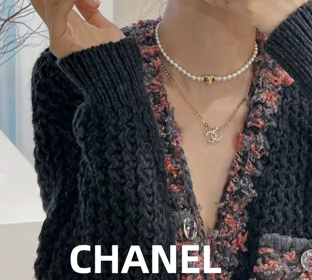 Layered pearl and gold-tone chain necklaces with small Chanel logo pendant