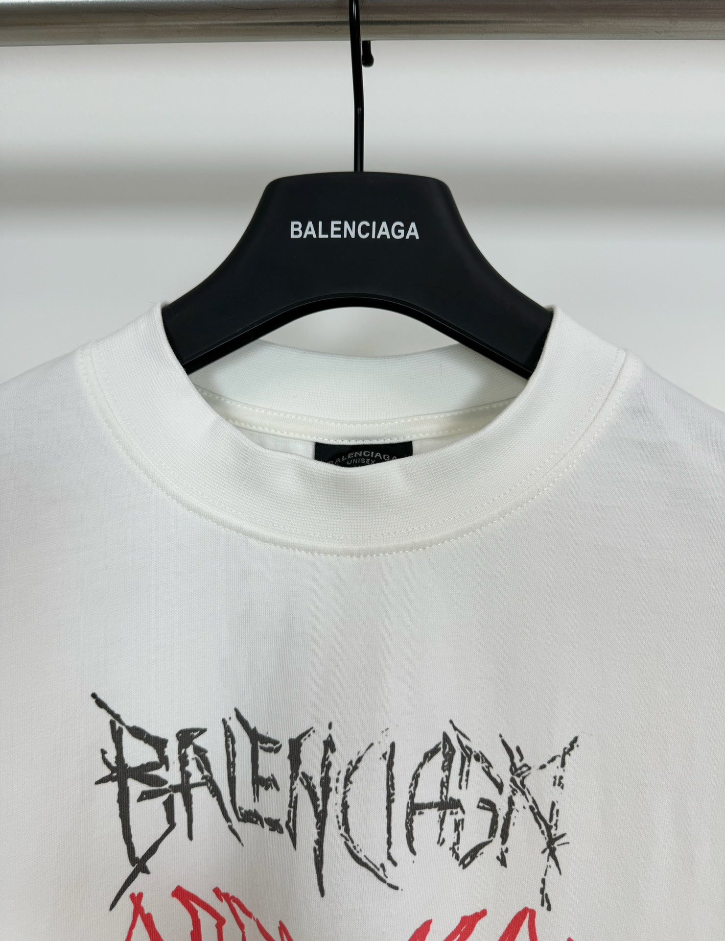 White crewneck T-shirt close-up of collar and black Balenciaga logo label