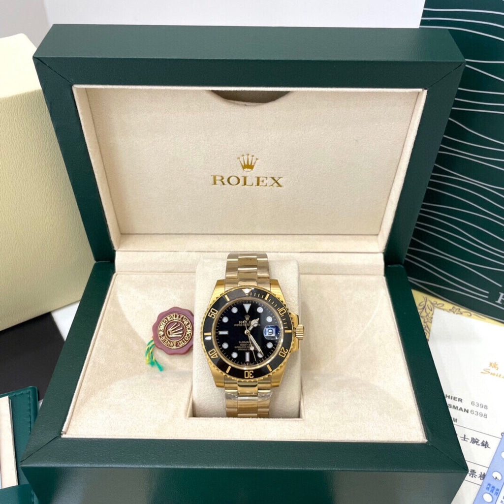 Rolex watch in open display box, black dial and gold-tone bracelet