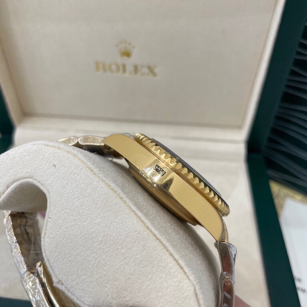 Rolex watch side profile with gold-tone crown and gold-tone case