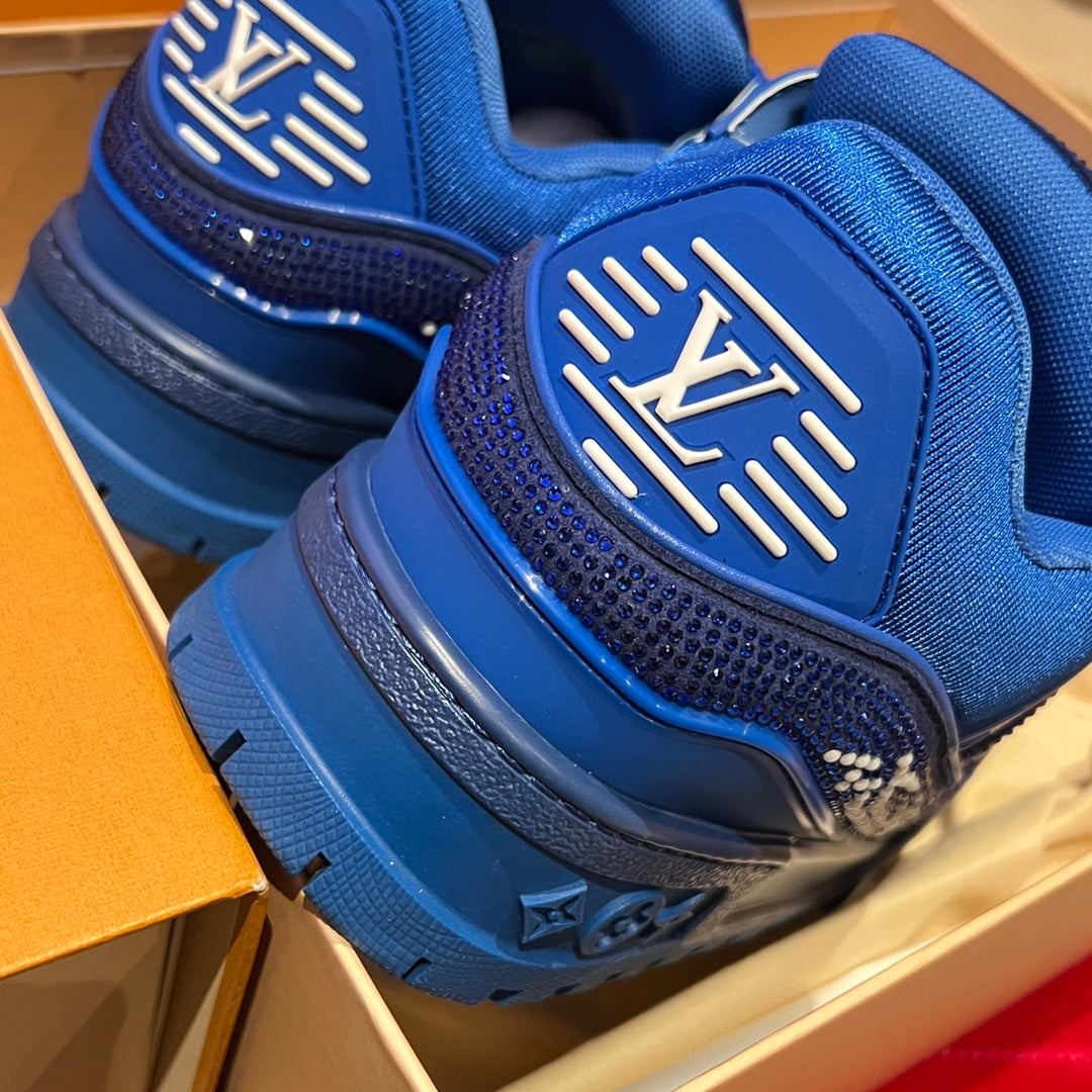 Blue sneaker heel detail with raised logo patch and textured rubber sole