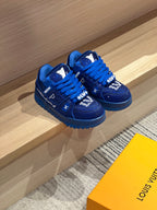 Pair of blue lace-up sneakers with chunky rubber sole and logo detail