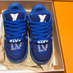 Blue lace-up sneakers showing toe caps with rhinestone emblem and LV-style marks